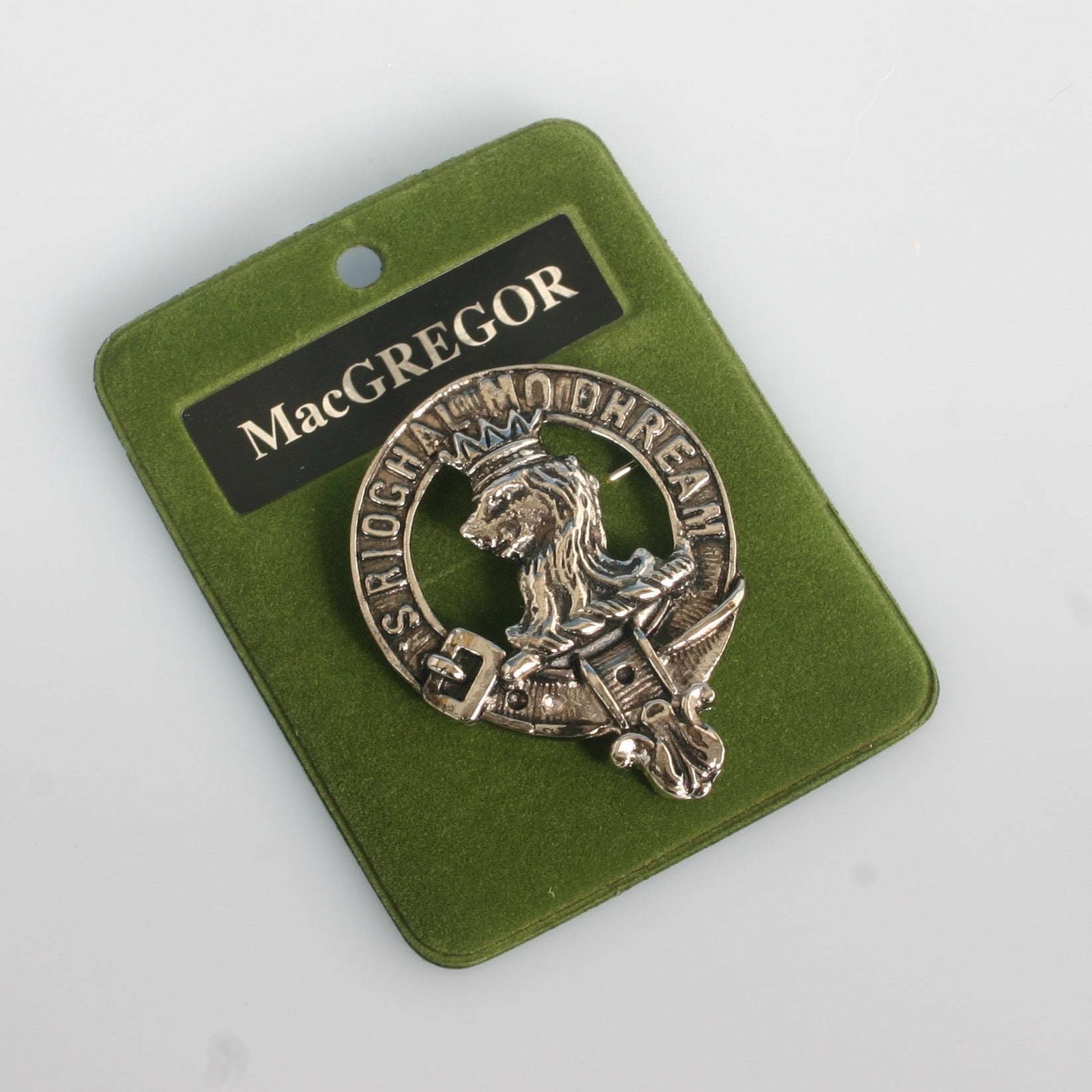 MacGregor Clan Crest Badge in Pewter featuring a traditional design ideal for showcasing clan pride. Crafted from durable palladium coated pewter, sized at 40mm (1.75") for wearing as a cap badge or brooch pin.